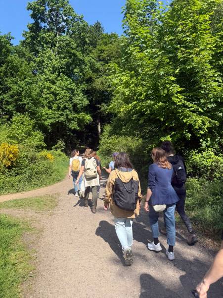 Foto vom UX Wandertag, eine Gruppe von Personen, die einen Waldweg entlanggeht